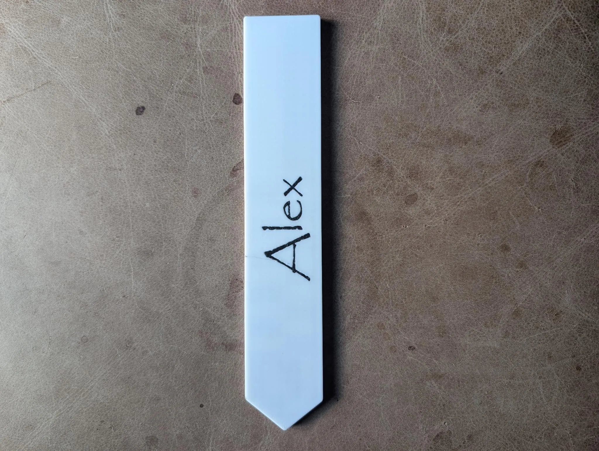 A blank white printed north arrow with a name written on it in marker